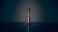 cigarette standing upright and burning with a lot of ash still on the cigarette