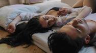 Couple lying on the edge of a bed