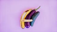 A banana next to an aubergine and courgette